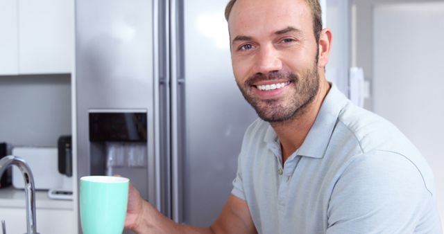 Smiling Man Relaxing at Home with Morning Coffee in Modern Kitchen - Download Free Stock Images Pikwizard.com