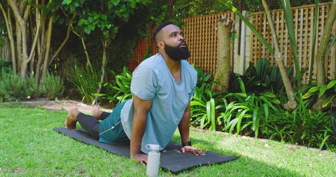Man Practicing Yoga in Lush Backyard Setting