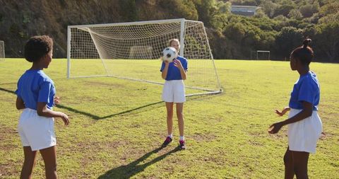 Young Diverse Girls Practicing Soccer on Sunny Field