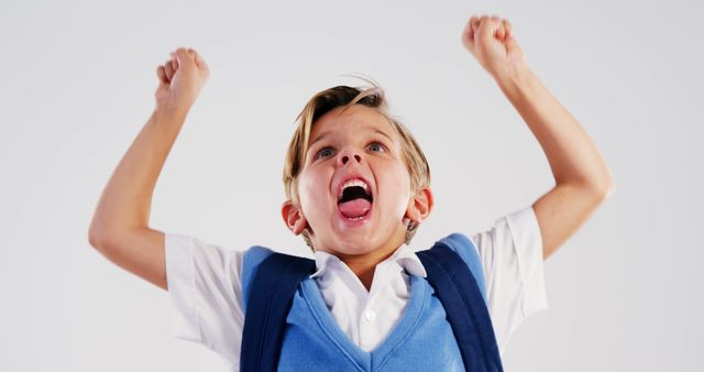 Excited Young Boy Celebrating Success with Raised Arms - Download Free Stock Images Pikwizard.com