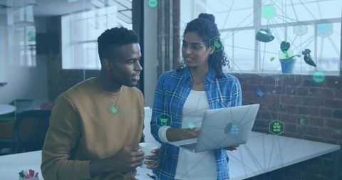 Creative Colleagues Discussing Tech Strategy in Modern Office