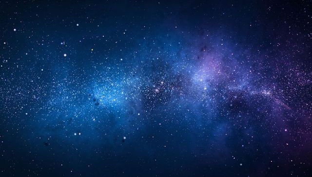 Milky Way Band Stretching Across Deep Night Sky with Blue-Purple Nebula Hues