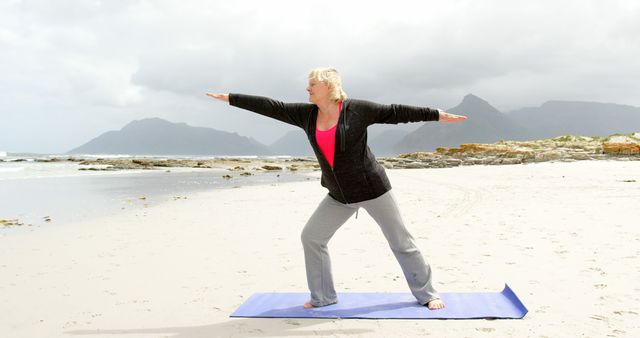 Woman Practicing Yoga on Beach with Mountain View in Background - Download Free Stock Images Pikwizard.com