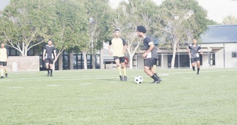 Teen Soccer Players Intensely Competing on School Field