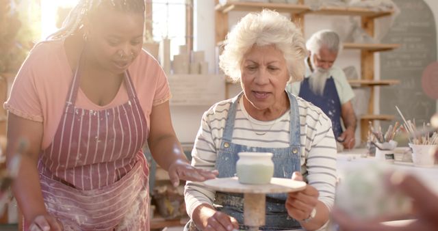 Elderly Woman Learning Pottery with Instructor in Art Studio - Download Free Stock Images Pikwizard.com