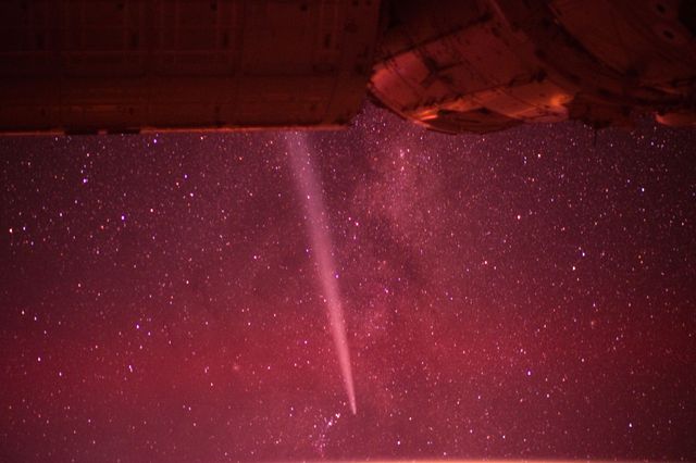 Capturing the striking view of Comet Lovejoy from the International Space Station on December 25, 2011, this infrared photo features a bright comet trail set against a backdrop of stars. Useful for astronomy enthusiasts, educators explaining space phenomena, and websites focused on celestial events or space exploration.