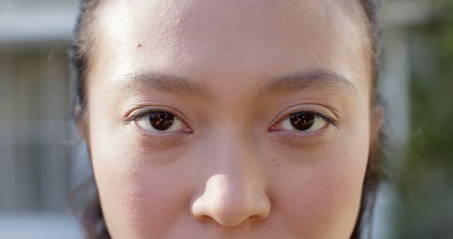 Portrait close up of opening eyes of happy biracial woman outdoors, slow motion. Happiness, wellbeing, tranquility and healthy lifestyle, unaltered.