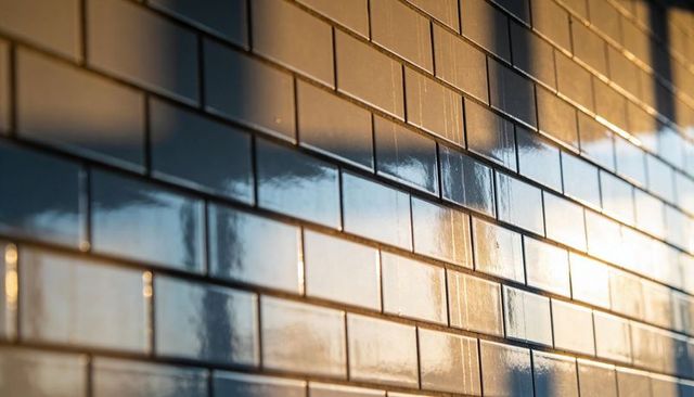 Glossy Subway Tile Wall Reflecting Warm Sunset Light and Window Shadow