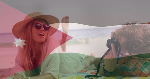 Vacation Freedom: Beach Relaxation Posing over Jordan Flag