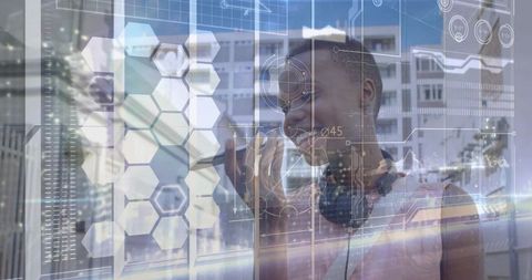 Young woman interacting with augmented reality holographic interface on glass in tech lab