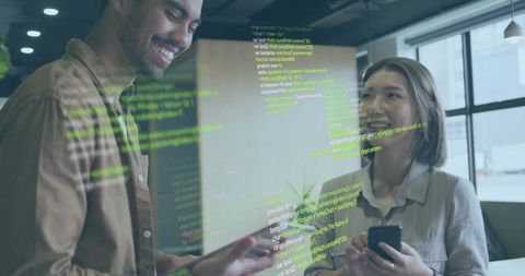 Developers Collaborating Over Code in Modern Office Environment
