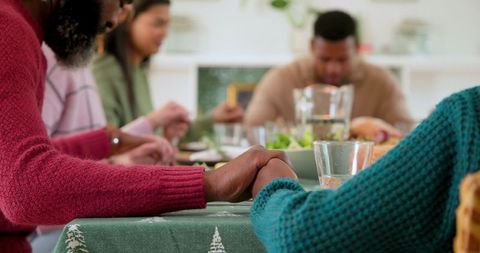 Diverse Family Unified at Dining Table in Warm Holiday Gathering
