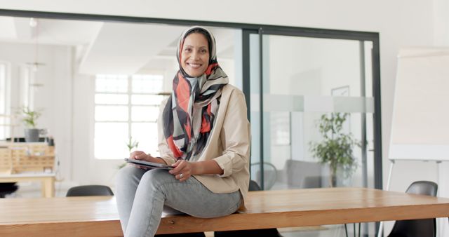 Confident Professional Woman in Hijab Smiling at Camera in Office - Download Free Stock Images Pikwizard.com