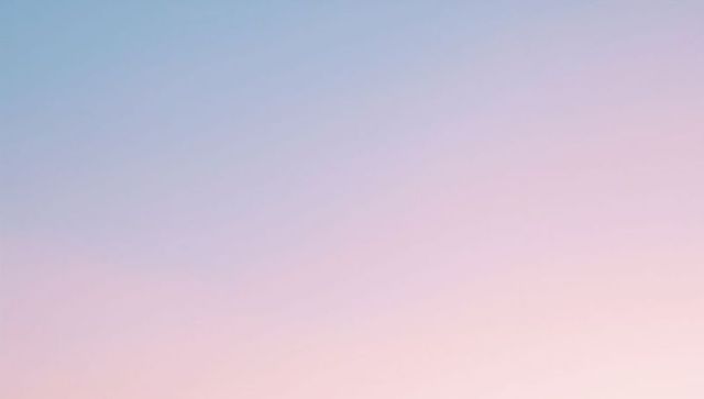 Glowing pastel gradient sky at dawn filling frame with soft pink and blue omre