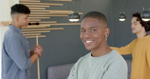 Young men socializing in modern lounge smiling while preparing for billiards game, casual hangout