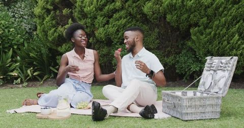 Joyful Couple Enjoying Picnic Outdoors in Blissful Meadow