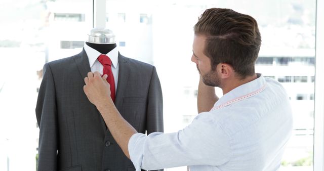 Fashion Designer Adjusting Red Tie on Mannequin in Bright Studio - Download Free Stock Images Pikwizard.com