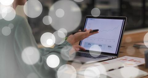 Pointing professional presenting laptop analytics chart, discussing growth metrics