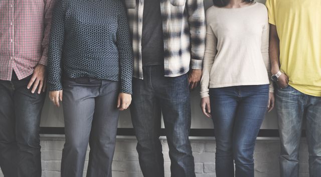 This image features a diverse group of people standing together in casual clothing, showcasing a sense of unity and diversity. Suitable for use in contexts promoting teamwork, community, inclusivity, or diversity initiatives. Ideal for businesses, educational content, non-profit organizations, and social campaigns.