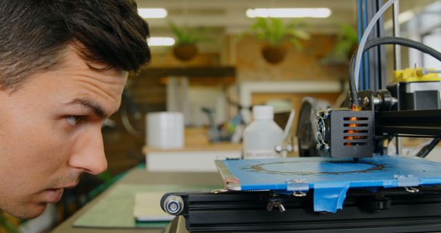 Focused Man Looking at 3D Printer in Workshop - Download Free Stock Images Pikwizard.com