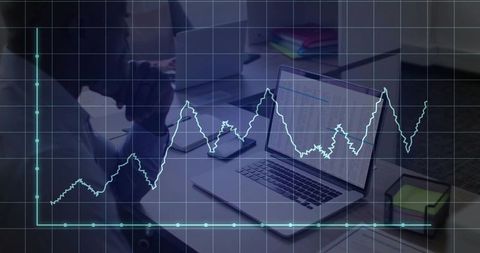Analyzing Data Trends on Laptop in Corporate Workspace
