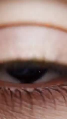 Macro Eye Revealing Rotating Nebula Spiral in Iris Cosmic Orb Overlay Vertical Video Loop