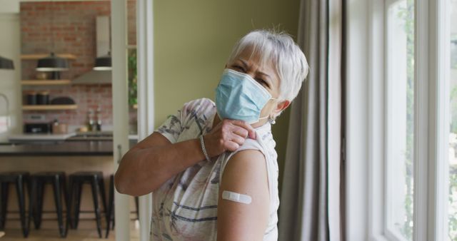 Senior Woman Showing Vaccination Bandage at Home - Download Free Stock Images Pikwizard.com