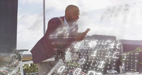 Businessman Viewing Smartphone Data While Leaning on Bicycle