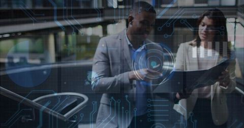 Two Professionals Analyzing Holographic Interface in Modern Office