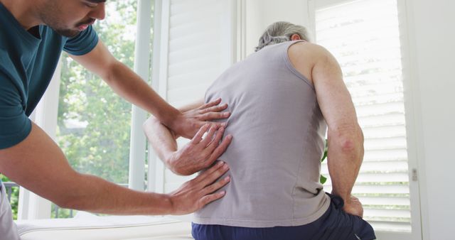 Physiotherapist Treating Elderly Man with Back Pain - Download Free Stock Images Pikwizard.com