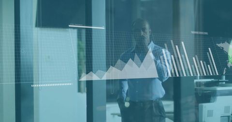 Businessman Analyzing Financial Data on Virtual Screen in Office
