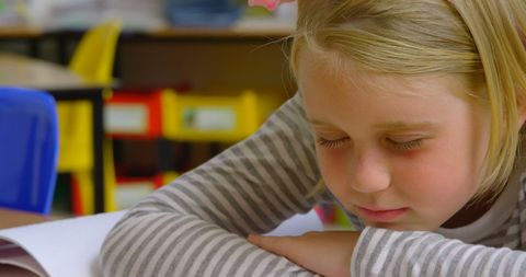 Young Schoolgirl Sleeping on Desk in Classroom Quiet Moment - Download Free Stock Images Pikwizard.com