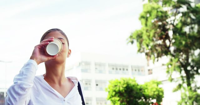 Young Professional Drinking Coffee Outdoors in Urban Setting - Download Free Stock Images Pikwizard.com