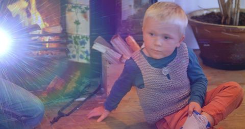 Father Playing Guitar for Son by Cozy Fireplace