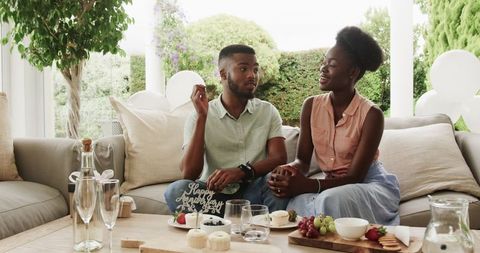 Couple Celebrating Romance with Cake in Cozy Home Setting
