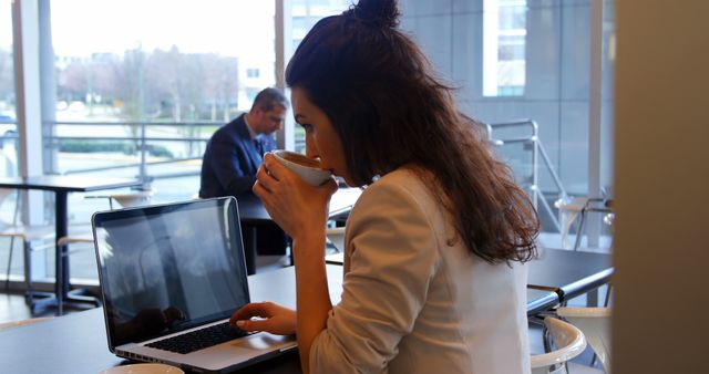 Woman Working on Laptop in Modern Cafe While Drinking Coffee - Download Free Stock Images Pikwizard.com