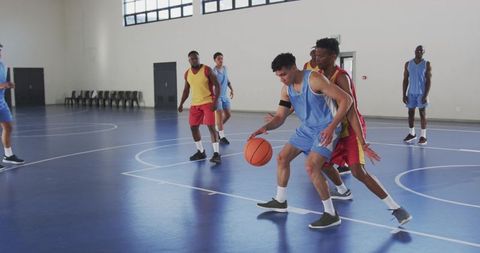 Diverse Men Playing Competitive Basketball Indoor Court