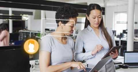 Collaborating Professionals Utilizing Technology in Modern Workplace