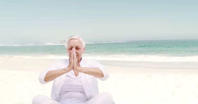 Senior Woman Meditating on Beach in White Clothing - Download Free Stock Images Pikwizard.com