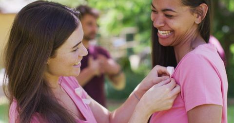 Women Smiling and Supporting Breast Cancer Awareness in Park - Download Free Stock Images Pikwizard.com