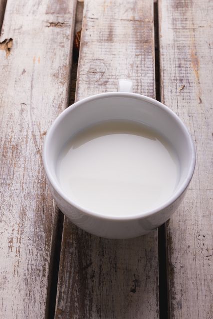 Cup of Milk on Rustic Wooden Table - Download Free Stock Photos Pikwizard.com