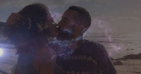 Romantic couple embracing amid celestial coastal dusk
