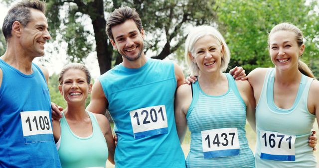 Group of Runners in Blue Activewear Smiling after Race in Park - Download Free Stock Images Pikwizard.com