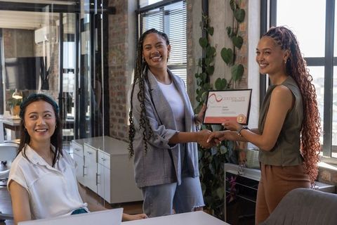 Female Colleagues Celebrating Corporate Achievement