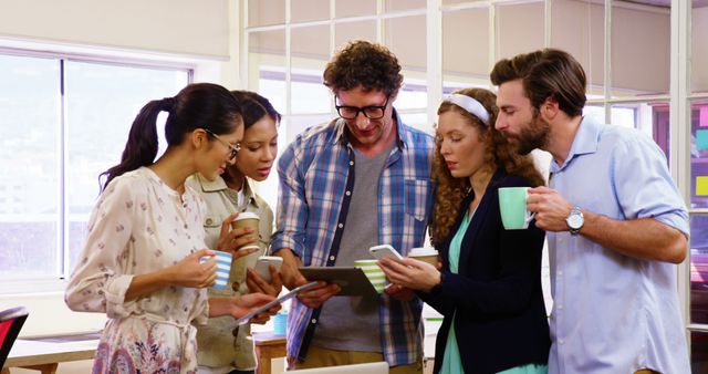 Diverse Team Collaborating Over Coffee and Digital Devices - Download Free Stock Images Pikwizard.com