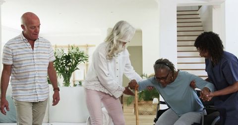 Senior friends assisting with mobility challenges at home