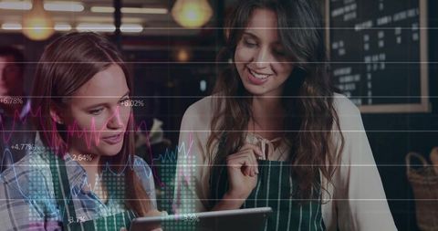 Two Baristas Collaborating and Analyzing Sales Data at Cafe