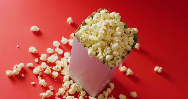 Box of Popcorn on Bright Red Surface with Scattered Kernels - Download Free Stock Images Pikwizard.com