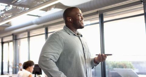 Confident Professional Engaged in Phone Conversation at Modern Office
