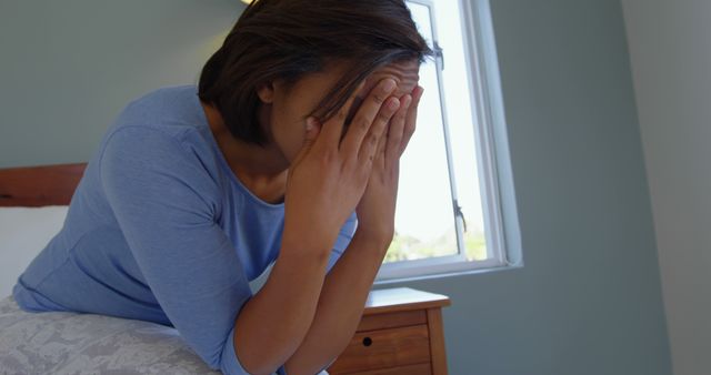 Stressed Woman Sitting on Bed Covering Face With Hands - Download Free Stock Images Pikwizard.com